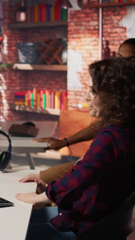 vertical video startup programmer collaborating with colleague to test company software