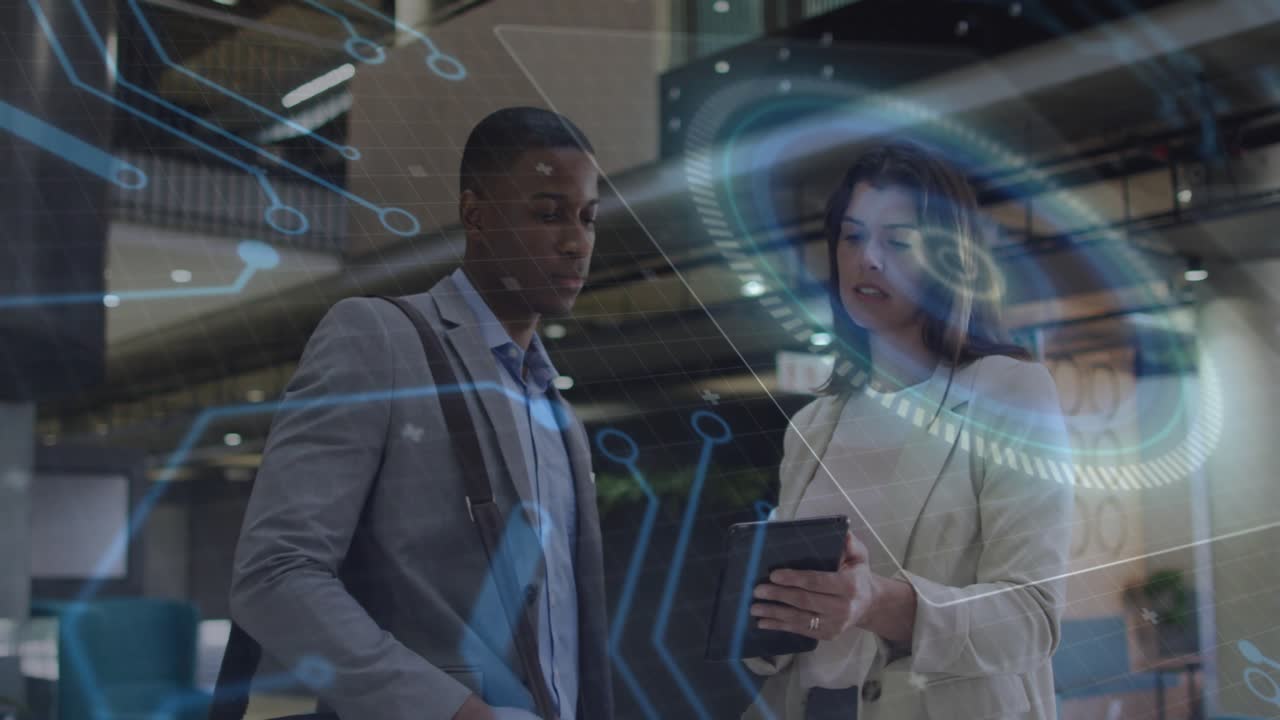 woman tapping tablet displaying holographic overlay as male colleague reviewing technology insights
