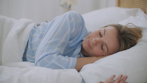 mujer joven acostada en la cama en el dormitorio con escamas escalofríos congelación sintiendo frío en casa sin problema de calefacción central en la temporada de frío enferma niña enferma envuelta en una manta con fiebre síntomas de gripe