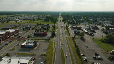 Flyover-above-cars-traveling-through-the-outskirts-of-Lawrence,-Indiana