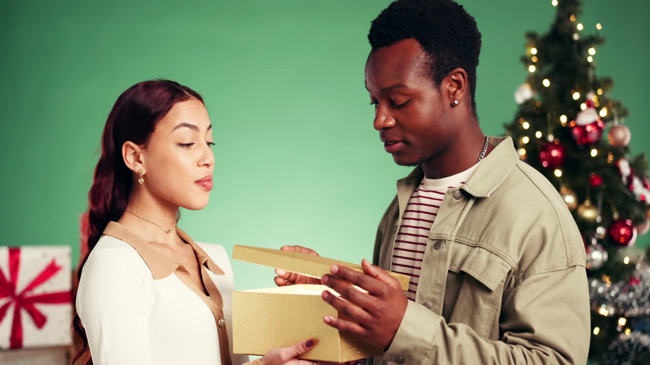 A happy couple celebrating Christmas with a surprise gift