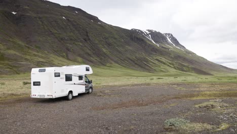 recreational vehicle in the mountains of iceland with gimbal video walking from behind