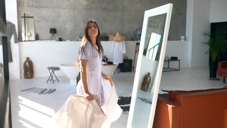 woman trying on clothes in front of a mirror