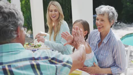 happy family eating together at table