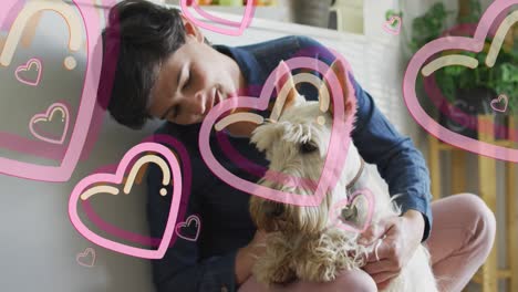 animation of hearts over caucasian woman with her pet dog