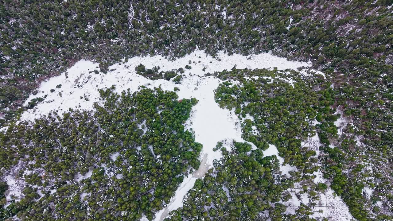 Drone footage shows remote village nestled among hills with steep escarpments