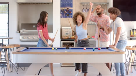 playing pool, group of diverse friends celebrating and having fun together indoors