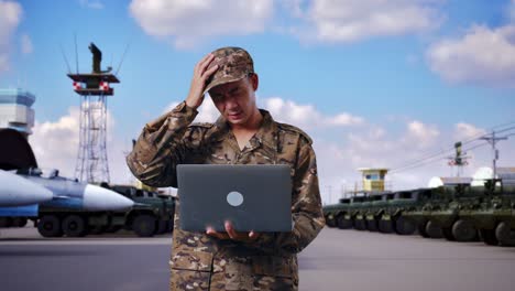 military personnel with laptop appears concerned