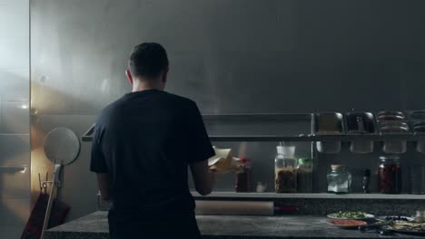 anonymous chef stretching and tossing pizza dough