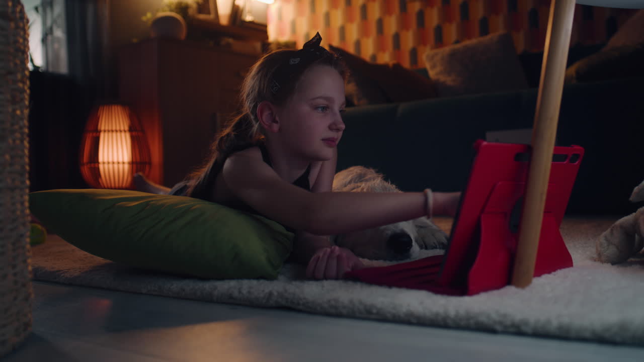 Girl and Dog Relaxing with Tablet at Home