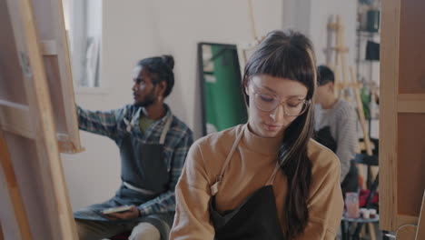art class students painting in studio