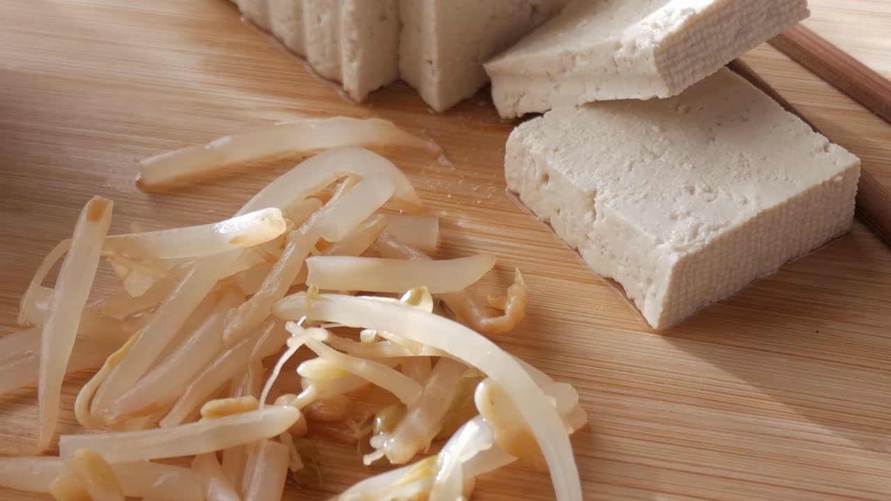 Fresh tofu and bean sprouts on wooden board, calm kitchen food prep moment