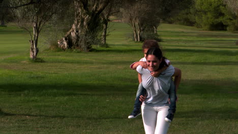 Mother-running-with-her-daughter-on-shoulder