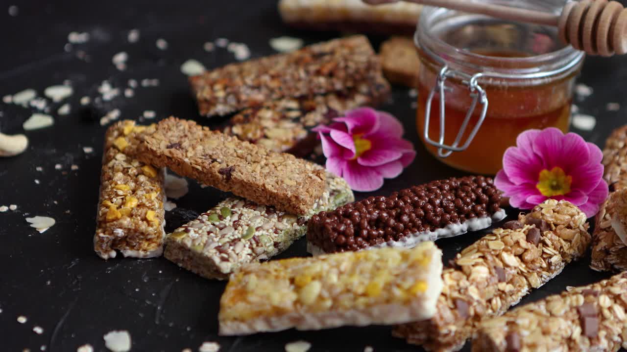 Healthy superfood composition  Various kinds granola energy protein bars with honey in jar