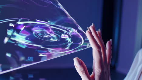hand interacting with a futuristic holographic display