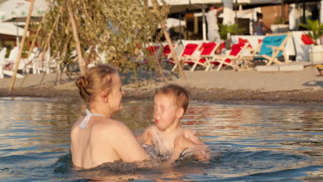 Mutter-Spielt-Mit-Ihrem-Kleinen-Sohn-Am-Strand