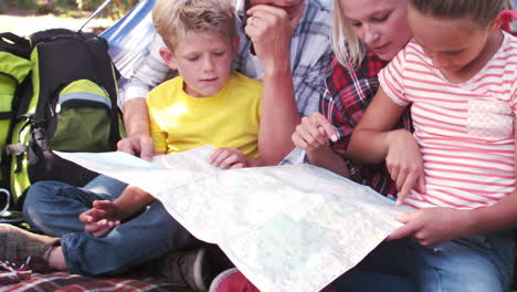 happy family on a camping trip in their tent