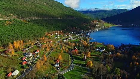 village on fjord green bank in norway