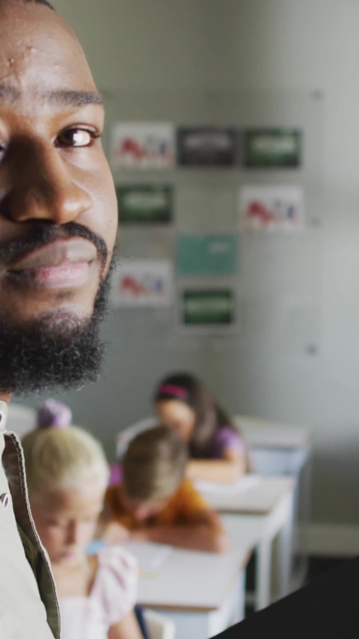 Animation of clock over african american male teacher with diverse pupils in classroom
