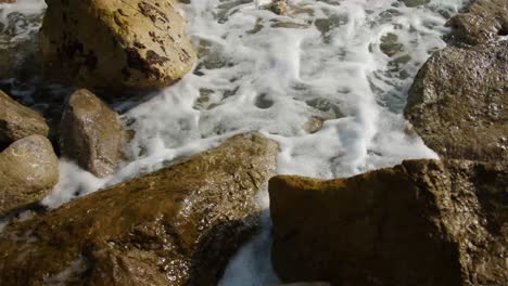 close shot of waves through the rocks in slow motion