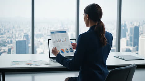 professional woman analyzing business data in modern high-rise office