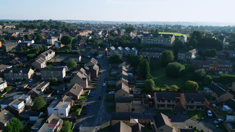 Witness-Staincliff,-UK,-from-above-in-this-drone-video,-showcasing-industrial-architecture,-bustling-streets,-Dewsbury-General-Hospital,-and-the-picturesque-Yorkshire-view-on-a-summer-morning