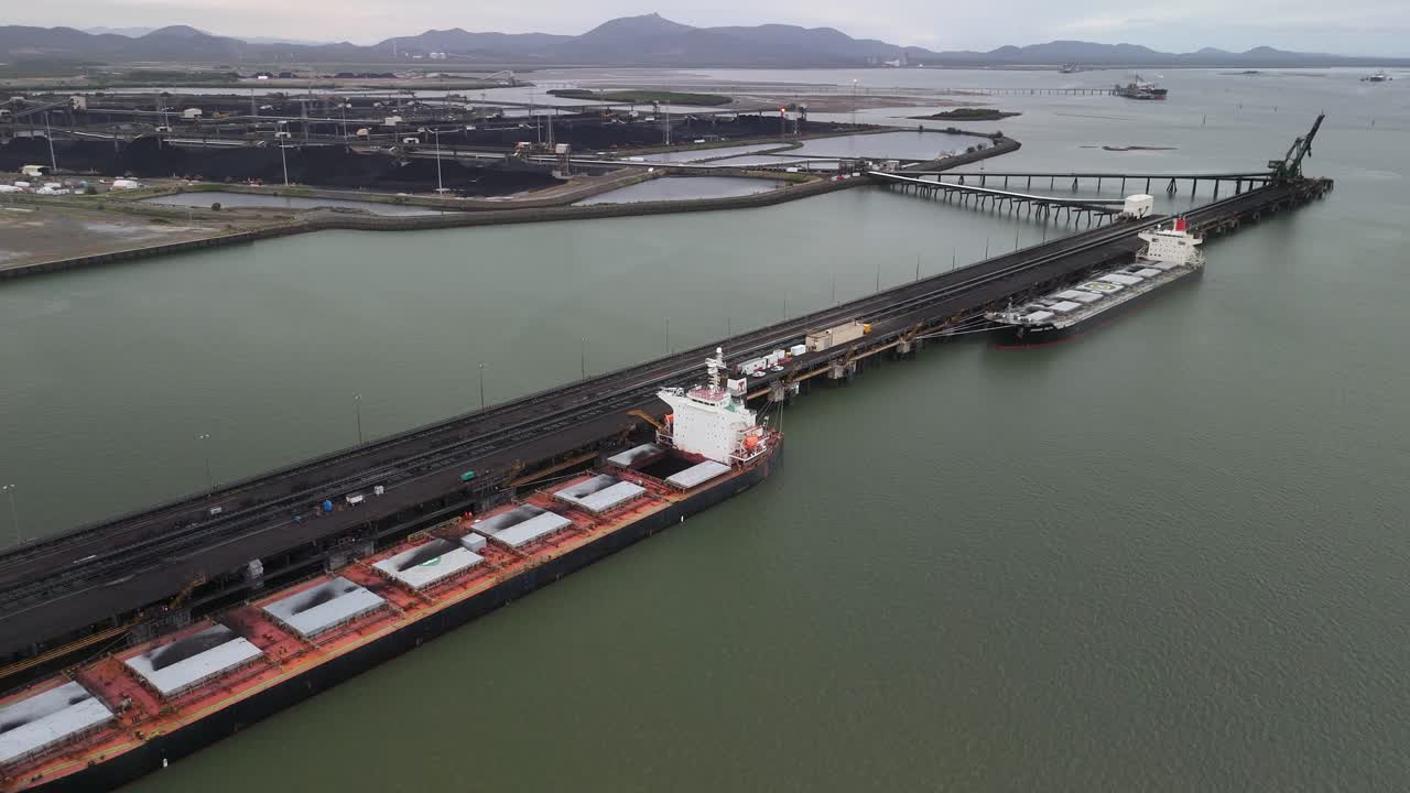 Aerial view of Gladstone coal terminal pier with freighters moored