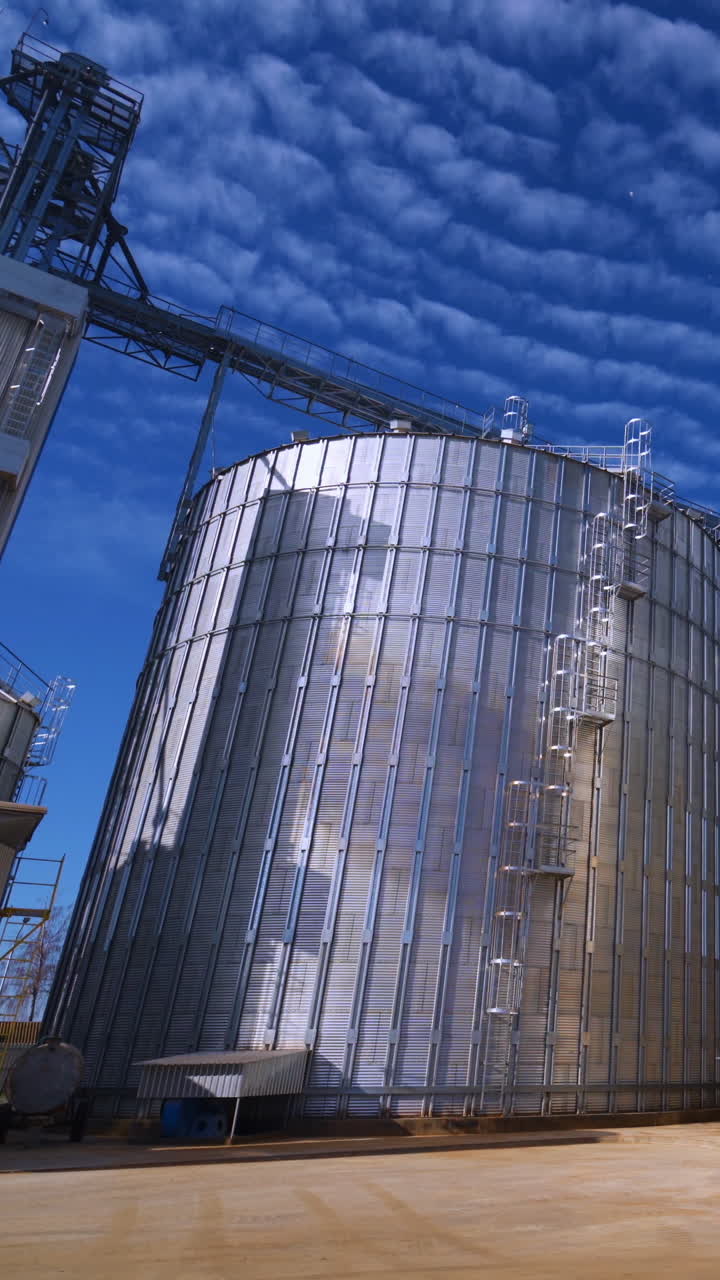 Large Grain Bins. Modern Granary elevator. Agribusiness. Vertical video