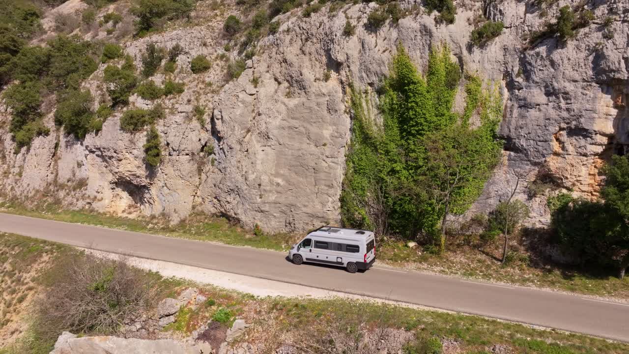 Aerial view of camper van on winding D177 road through gorge in Venasque