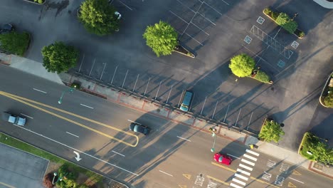 top down aerial view of street in american city and van on almost empty parking lot