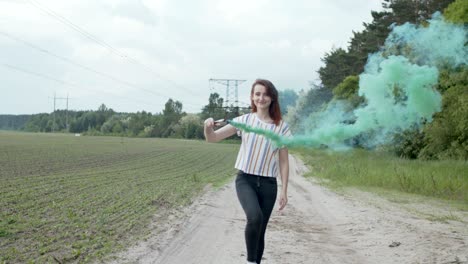 female walking on rural road through colored smoke