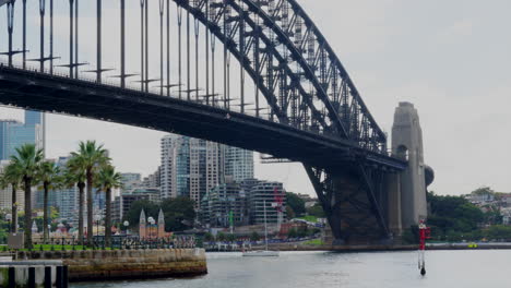 a private yacht sails under sydney harbour bridge in australia