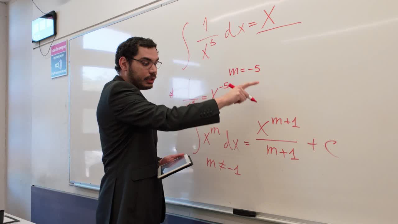 Man Solving a Complex Problem on a Whiteboard