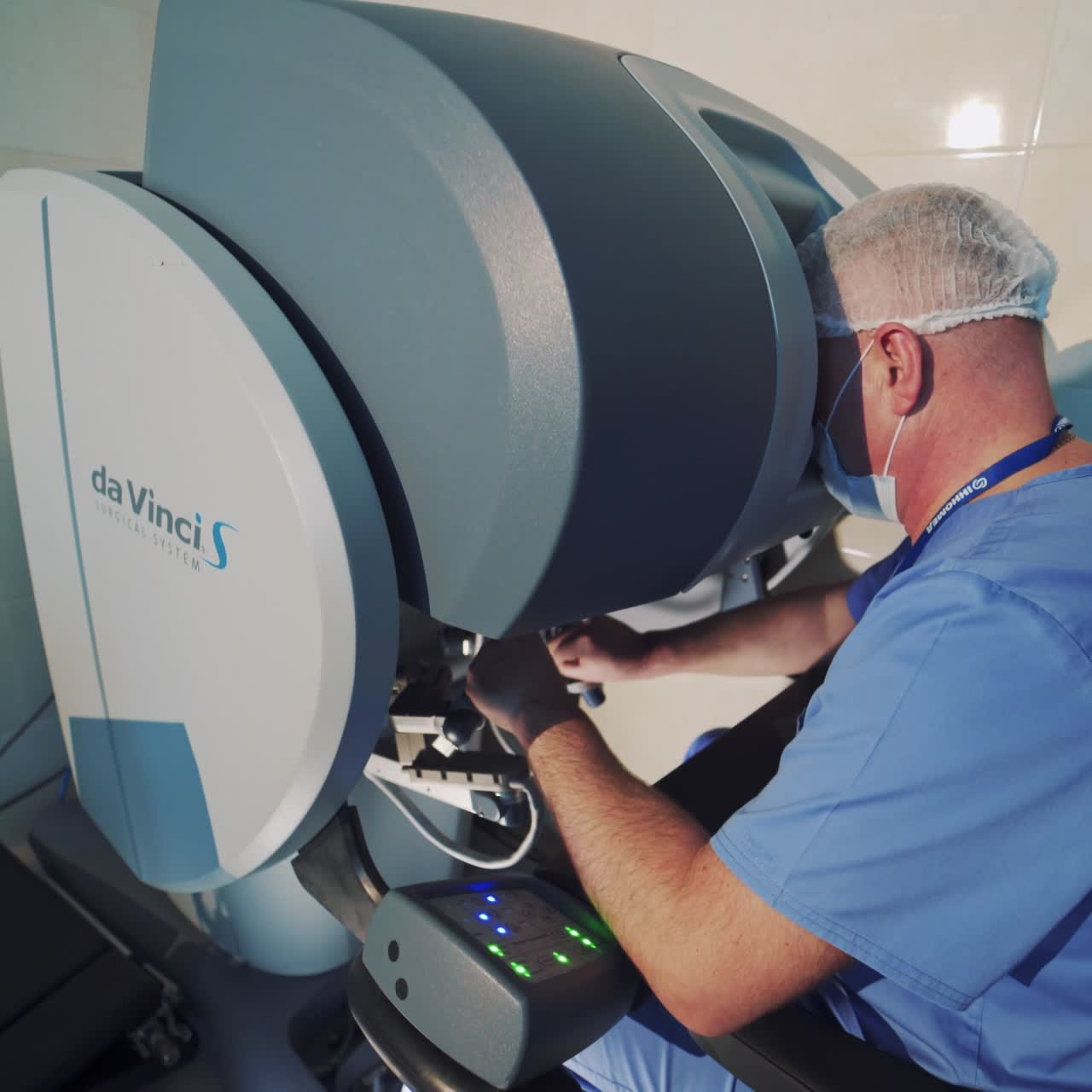 Surgeon operating medical robotic surgery machine. Manual control by minimally invasive surgical da Vinci System. Modern automated medical device.