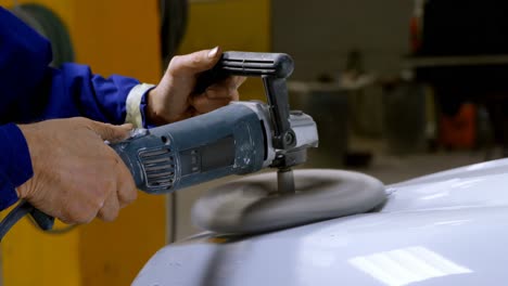 mechanic polishing a car with grinder 4k