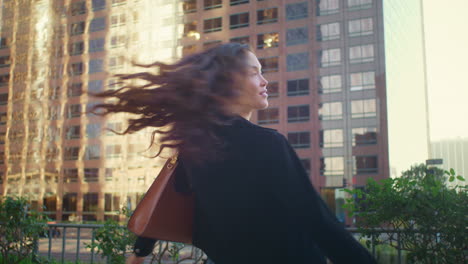 carefree woman having fun on walk. asian female whirling looking on camera.