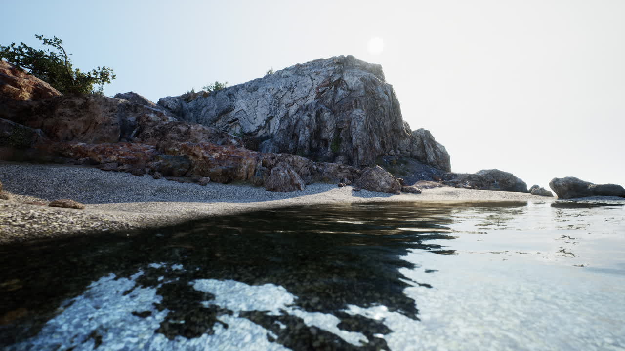 Rocky Beach with Clear Water and Sun