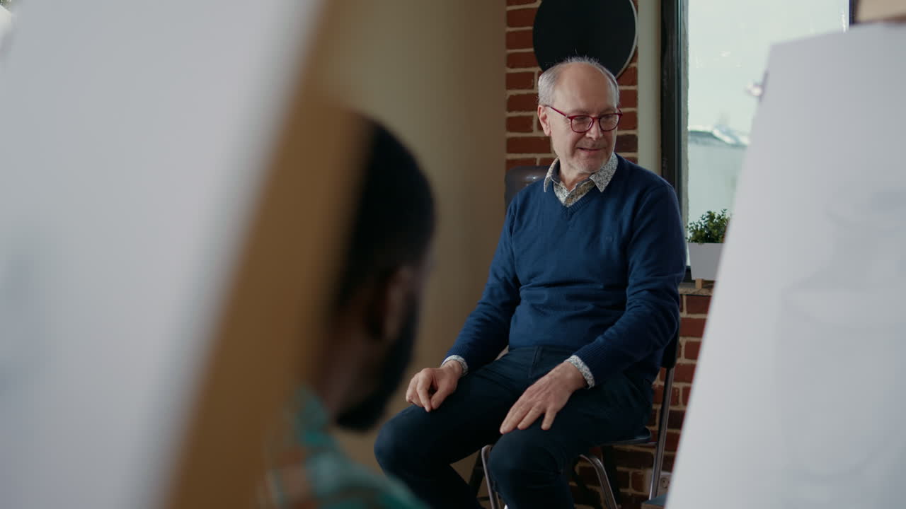 Senior teacher explaining art and craft skills at workshop