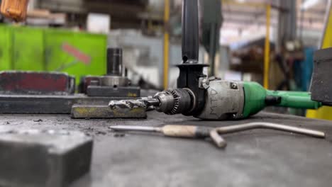 drills and other equipment scattered on the workshop table