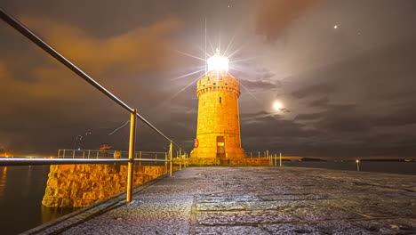 Castle-Lighthouse-Illuminated-With-Moon-Over-Cloudy-Evening-Sky-At-Saint-Peter-Port,-Guernsey