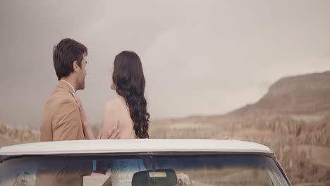 couple on open top car, romantic landscape