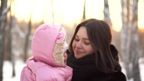 mother and baby in winter park