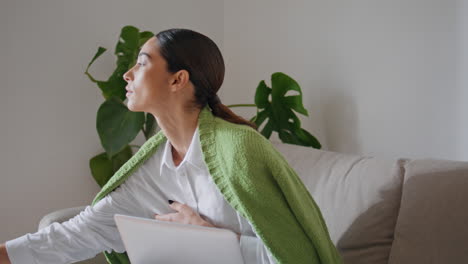 relaxed woman sipping tea resting cozy couch close up. student working laptop