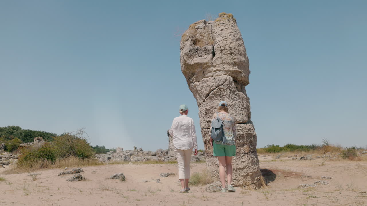 Two women exploring a stone forest
