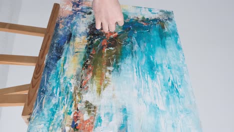 artist hand painting abstract art on canvas