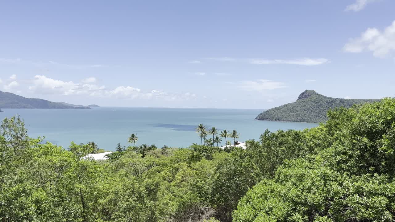 Hamilton tropical island, Whitsundays overlooking coast to right of bay with peninsula nob