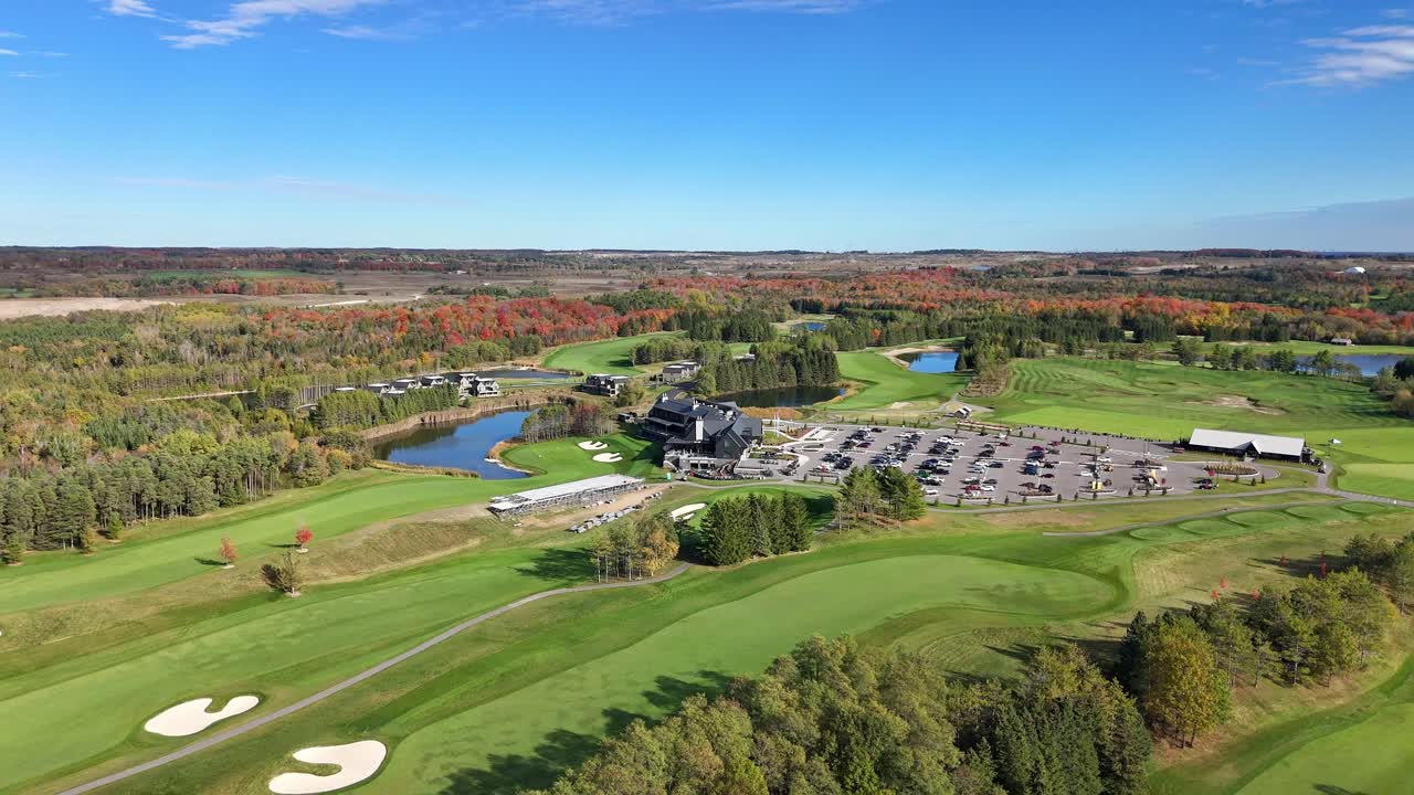 Stunning bird’s eye aerial view of a golf resort surrounded by lush, mowed green lawns at TPC Toronto Osprey Valley Golf Course in Caledon, Ontario, Canada