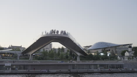 modern pedestrian bridge overlooking the river at sunset