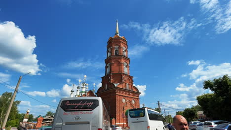 orthodox church with bell tower and bus