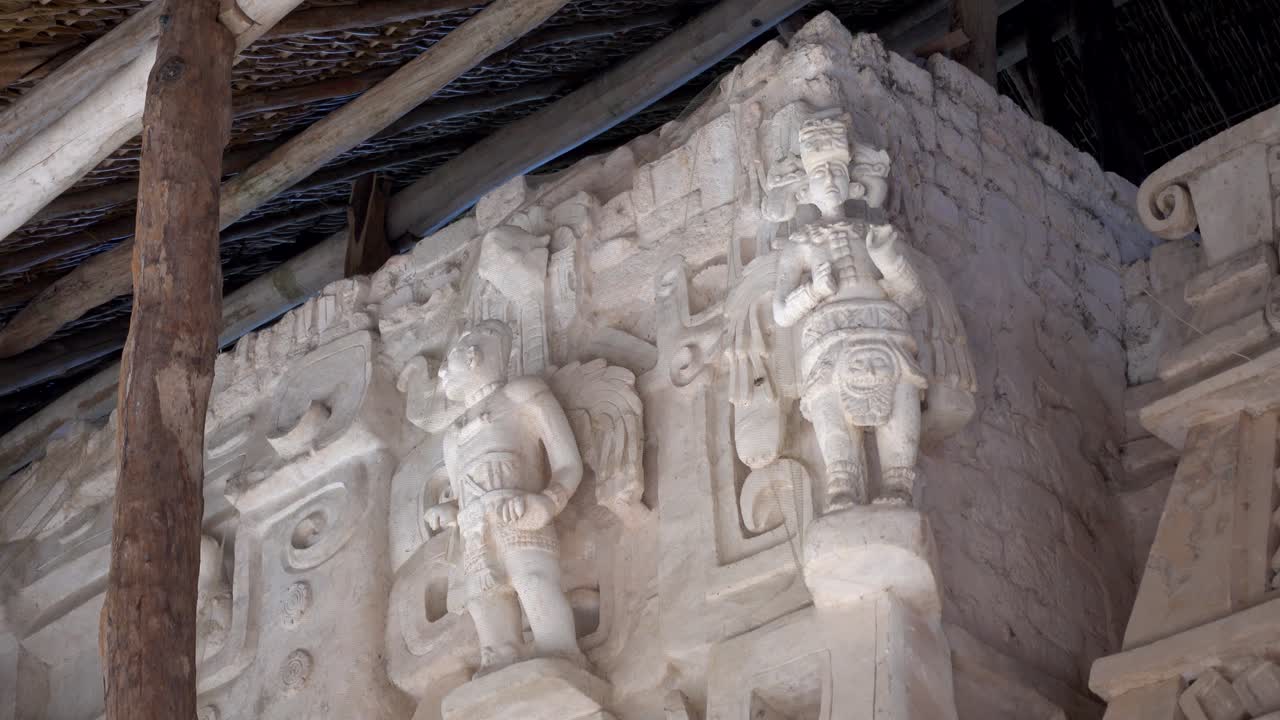 Closeup panning up showing the intricate sculptures on east side of the Jaguar altar on the Acropolis at Ek Balam archaeological site